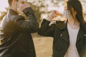 pareja_con_mascarilla_saludandose